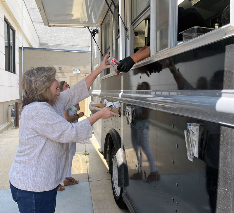 Employee getting lunch from a food truck.